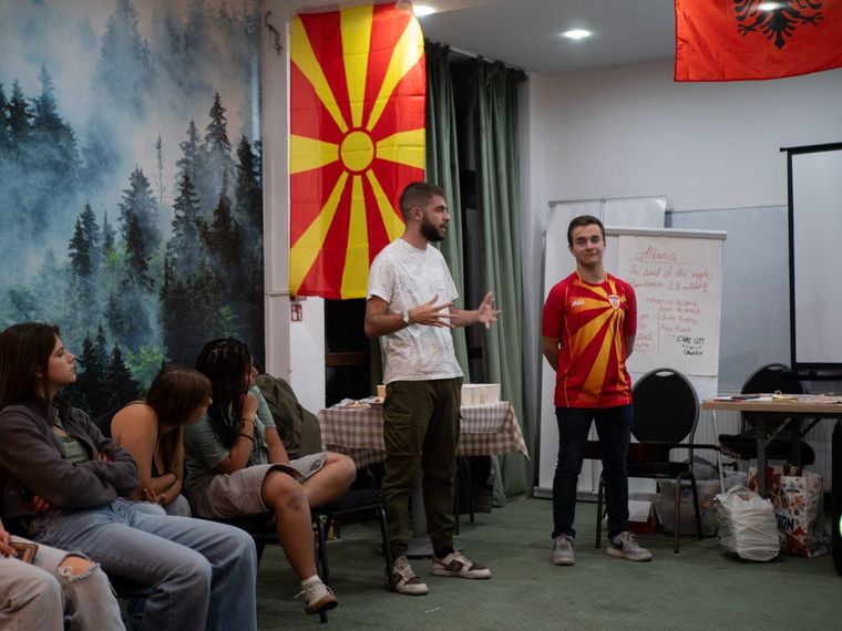 Two participants leading a session while the group listens